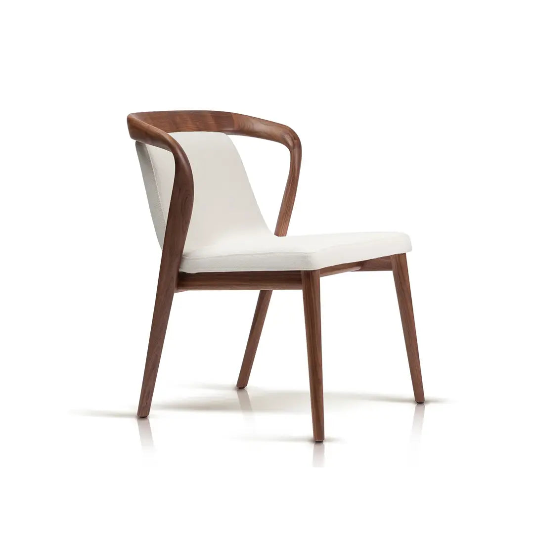 Modern walnut dining chair with white upholstery and a smooth curved backrest, standing on an isolated background, showcasing elegance and comfort.