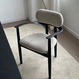 Modern chair with gray cushioned seat and backrest on a light-colored floor.