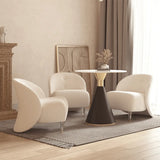 A cozy living room setup featuring two Alpine Shearling Armless Chairs in soft white fabric, paired with a modern black and gold round table on a textured grey rug.