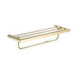 A wall-mounted towel rack with a brass gold finish. The rack features a rectangular frame with horizontal bars on the top shelf designed to hold folded towels or other bathroom items. Below the shelf, there is a single horizontal bar for hanging additional towels.