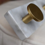 Gold cylindrical object on a marble block