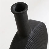 Close-up of a textured black ceramic vase with a narrow opening, showcasing a fine ribbed design and a matte finish.