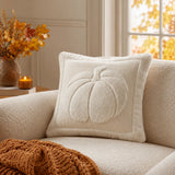 Ivory bouclé pumpkin Halloween cushion pillow with cream woven fabric and plush textured border