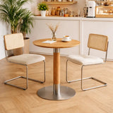 Modern round wood-finish high coffee table with metal pedestal base in a contemporary interior