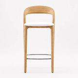 Designer bar stool with curved oak wood backrest, white seat and metal footrest for kitchen island
