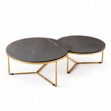 Set of 2 round nesting coffee tables with dark grey marble-effect tops and gold legs in a contemporary UK lounge