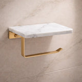 Wall-mounted toilet roll holder with white marble shelf and brushed gold arm in a luxury bathroom setting