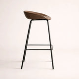 Bar stool with wooden seat and black metal legs on a light background