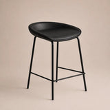Black bar stool with a beige background