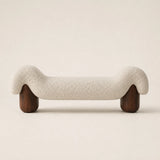 Front view of the Haven cream boucle bedroom bench with sculptural upholstered seat and two dark wood legs
