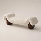 Haven designer boucle bench with cream textured upholstery and dark wood legs in a three-quarter studio view