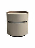 Round beige ottoman with a dark brown top on a white background. Designer bedside table UK—bespoke saddle leather in tan