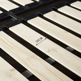 Close-up of natural pine wood slats on a bed frame with a 10cm gap marking, highlighting sturdy and breathable mattress support.