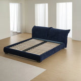 Minimalist navy blue upholstered bed frame with exposed slat base in a bright, contemporary bedroom setting.