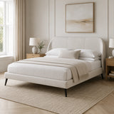 White upholstered super king bed frame with curved panelled headboard and black legs, styled in a neutral modern UK bedroom