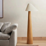 Maple Oak Haven Wooden Floor Lamp placed in a minimalist living room setting, adding warmth and elegance with its natural wooden texture and soft lighting