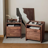 Pair of Mid-Century Modern bedside tables made from solid black walnut wood, featuring a minimalist design with ample storage space, adding a touch of elegance to any bedroom setting.