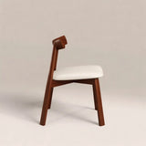 Wooden chair with white cushion on a beige background