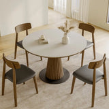 Scandinavian round dining table set with wooden chairs in a bright minimalist dining room UK