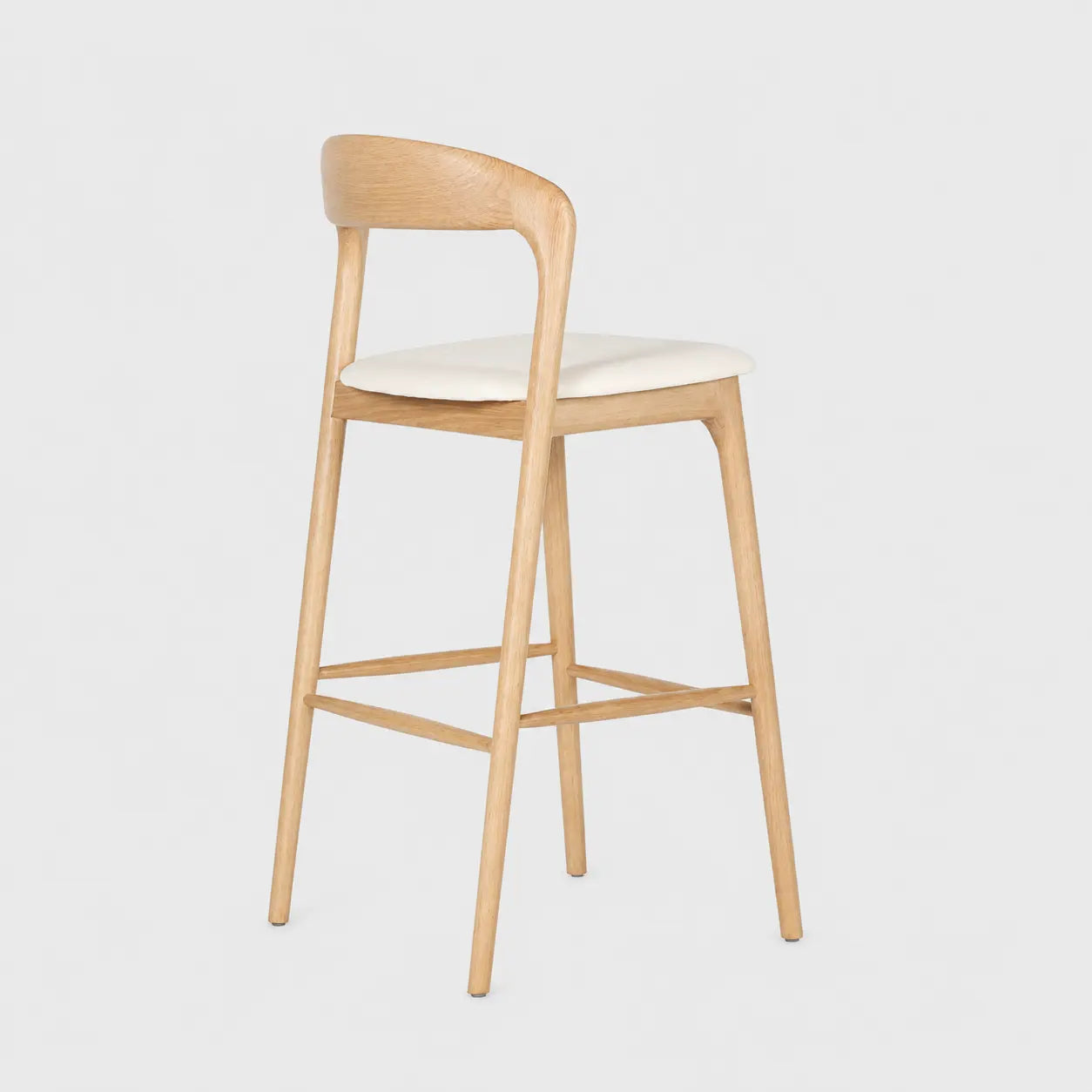 Front view of a raw wood bar stool with ash wood frame and cushioned white seat, combining mid-century bar stool style with clean lines for stylish home bar seating.