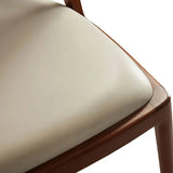 Close-up of the cream upholstered seat and light walnut-finished ash wood frame on the Twickenham dining chair