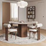 Elegant dining room featuring a set of mid-century modern chairs with cylindrical upholstered backrests and cushioned seats in neutral fabric. The chairs are paired with a round wooden dining table on a textured area rug, complemented by a soft white pendant light and a wall-mounted magazine rack for a sophisticated contemporary aesthetic at Brightly home London