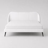 Side view of a modern white upholstered super king bed frame with curved headboard and slim black legs