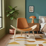 Modern living room with a brown chair, lamp, and plant.