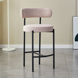 A contemporary Whittington Teddy Delightful Bar Stool with a two-tiered plush pink seat and a supportive backrest, set against a simple modern interior with a grey floor and a white floor lamp in the background.