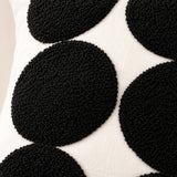 Close-up of black tufted polka dot detailing on the natural cotton Polka Dot Tufted Cushion