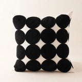 Front view of the 45cm Polka Dot Tufted Cushion with oversized black tufted circles on natural cotton