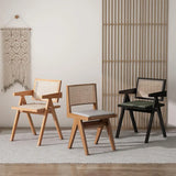 A trio of stylish dining chairs, each featuring a distinctive rattan backrest design and a comfortable cushioned seat, set against a minimalist backdrop with a woven wall tapestry and bamboo room divider.