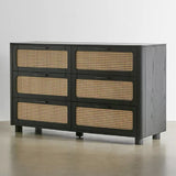 The Qienn Rattan Six Chest-of-Drawers with a black wood finish, combining modern design with natural rattan elements.