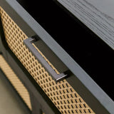  Close-up of a black rattan chest-of-drawers handle, showcasing its sleek, modern design with intricate woven detailing.