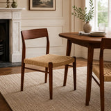 Wooden chairs with woven seats in a cozy living room setting.