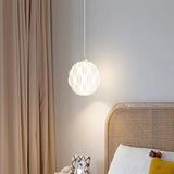 Elegant white leaf-patterned pendant light hanging in a serene bedroom, illuminating the space with a soft glow next to a wicker headboard and light curtains.