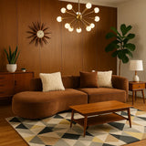 Modern living room with brown sofa, wooden coffee table, and decorative elements.