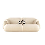 a contemporary 3-seater sofa, named Tofu, measuring 210cm in width. The sofa is upholstered in a soft, cream-colored fabric and features rounded, plush armrests and a minimalist design. It includes a decorative throw pillow with a black and white heart pattern, adding a touch of contrast and character to the overall look.