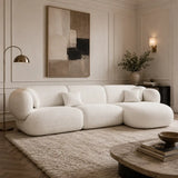 Tofu Large L-shape Corner Sofa in white upholstery, styled in an elegant modern living room with wall art, floor lamp and textured rug.