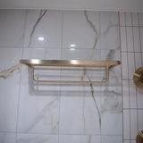 Luxurious brass towel hanger on a marble wall, combining minimalist design with functionality for bathroom spaces.