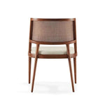 Rear angled view of the Twickenham dining chair showing its woven backrest, curved wooden frame and cream cushioned seat