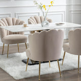 Dining room setup featuring the Elara Velvet Dining Chairs with gold legs, arranged around a marble dining table, creating a luxurious and modern dining space.