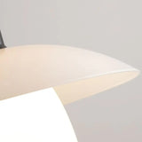 Close-up of a Verona Black pendant light shade showing a smooth, cream-colored surface, partially illuminated from within, highlighting its sleek and minimalist design.