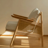 Wooden chair with woven backrest and cushion on a wooden floor.