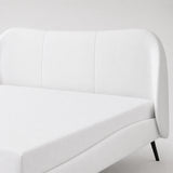 Close-up of a white curved headboard with panelled upholstery on a modern super king size bed frame