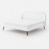Close-up of a white upholstered super king bed frame with tailored corner seams and slim black metal leg