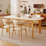 Scandinavian-style dining room with Benenden Solid Ash Dining Chairs in natural wood and white upholstery, paired with a light wood rectangular dining table for a cosy modern interior.
