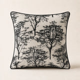 Woodland Cushion in cream textured fabric with a black tree pattern and black piping