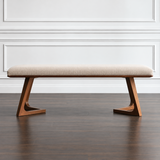 Mid-Century Northwood bedroom bench with cream upholstered seat and warm wood frame in a contemporary interior