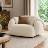 Beige armchair with a brown pillow in a living room setting